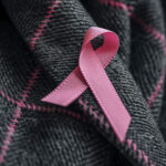 Pink breast cancer awareness ribbon symbolizing reflection, resilience, and support during Breast Cancer Awareness Month