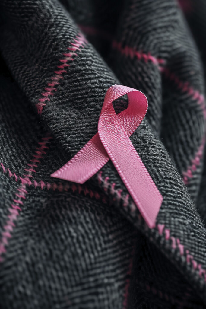 Pink breast cancer awareness ribbon symbolizing reflection, resilience, and support during Breast Cancer Awareness Month